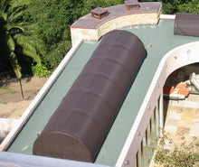 Barrel vaulted flat end skylight with a dark brown shade.